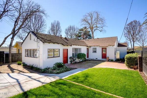 a view of a house with a small backyard