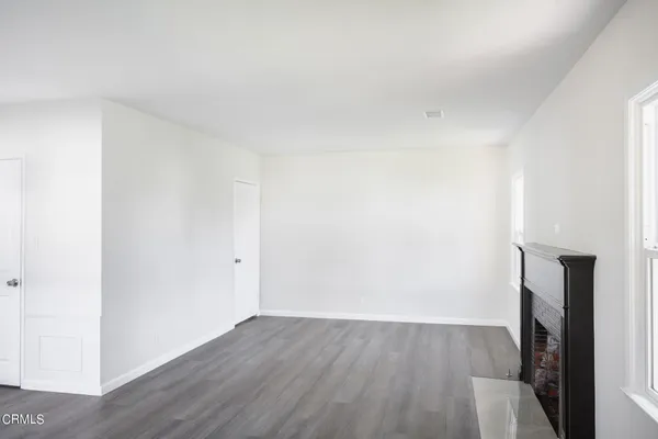 a view of a room with wooden floor