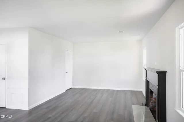 a view of a room with wooden floor