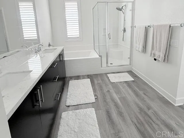 a bathroom with a tub sink and mirror