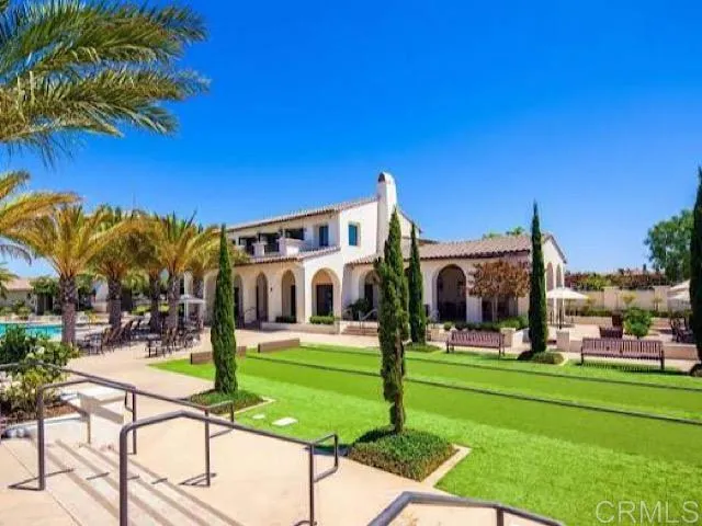 a view of a white house with a swimming pool