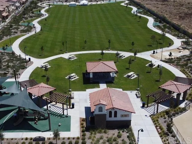 an aerial view of a house with a garden and lake view