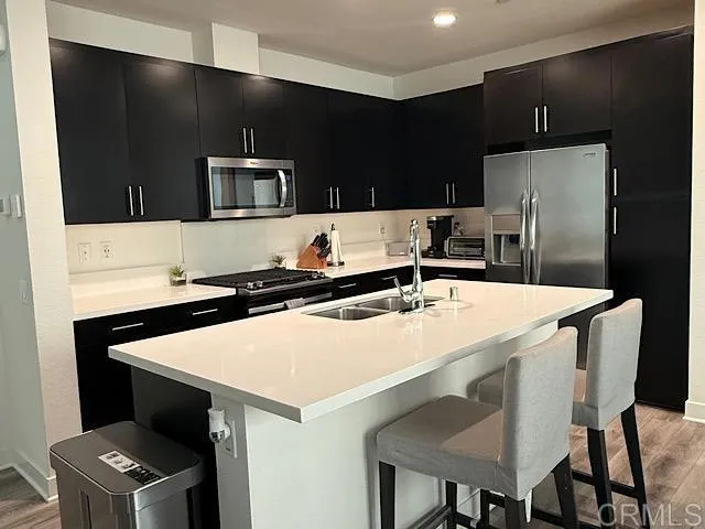 a kitchen with stainless steel appliances a sink and a refrigerator