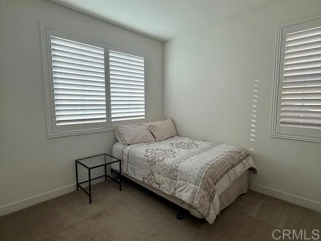 a bedroom with a bed chair and a window