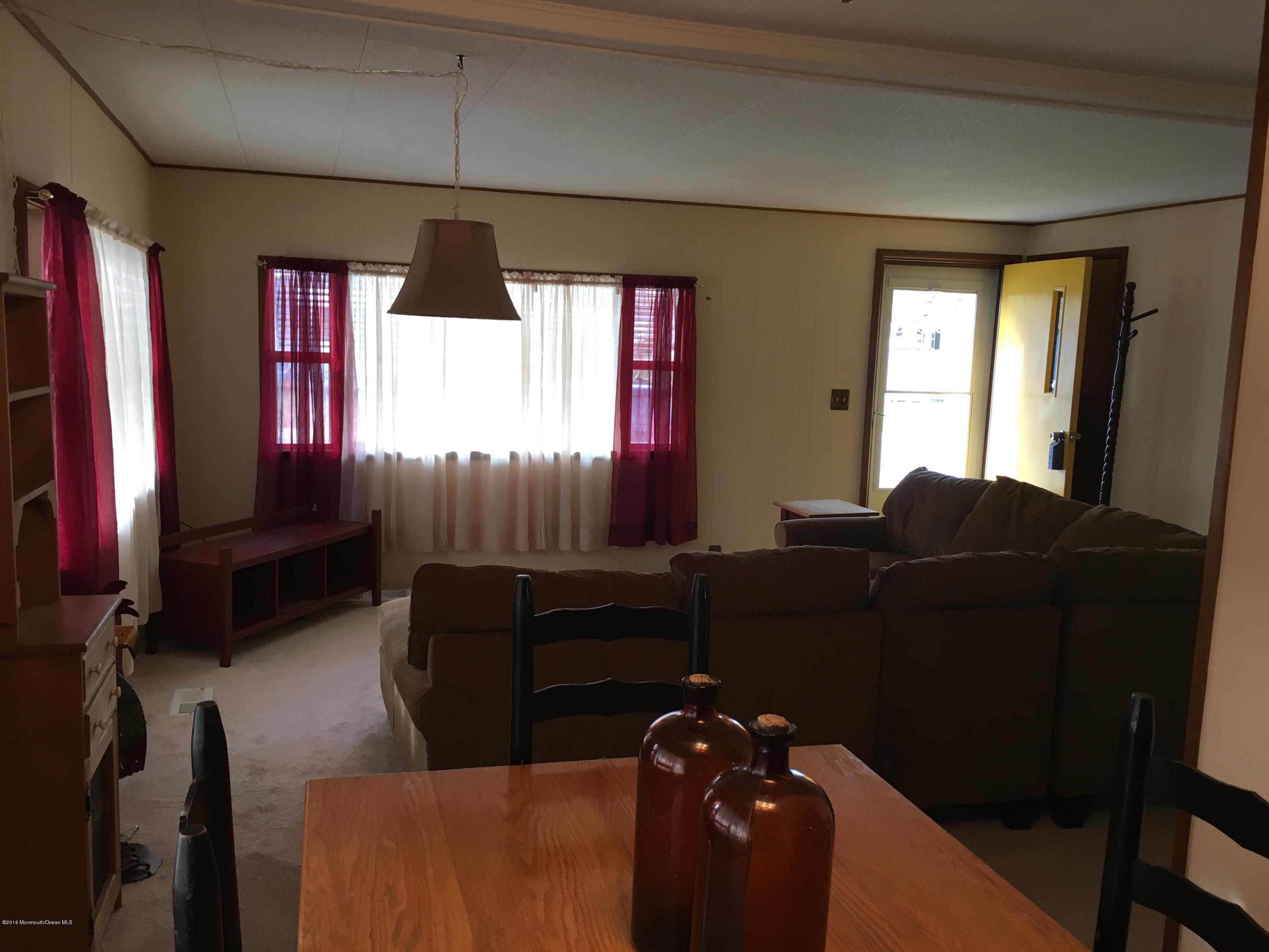 571 Cherin Road Freehold, NJ 07728 - Photo 7 of 17 a living room with furniture and a flat screen tv