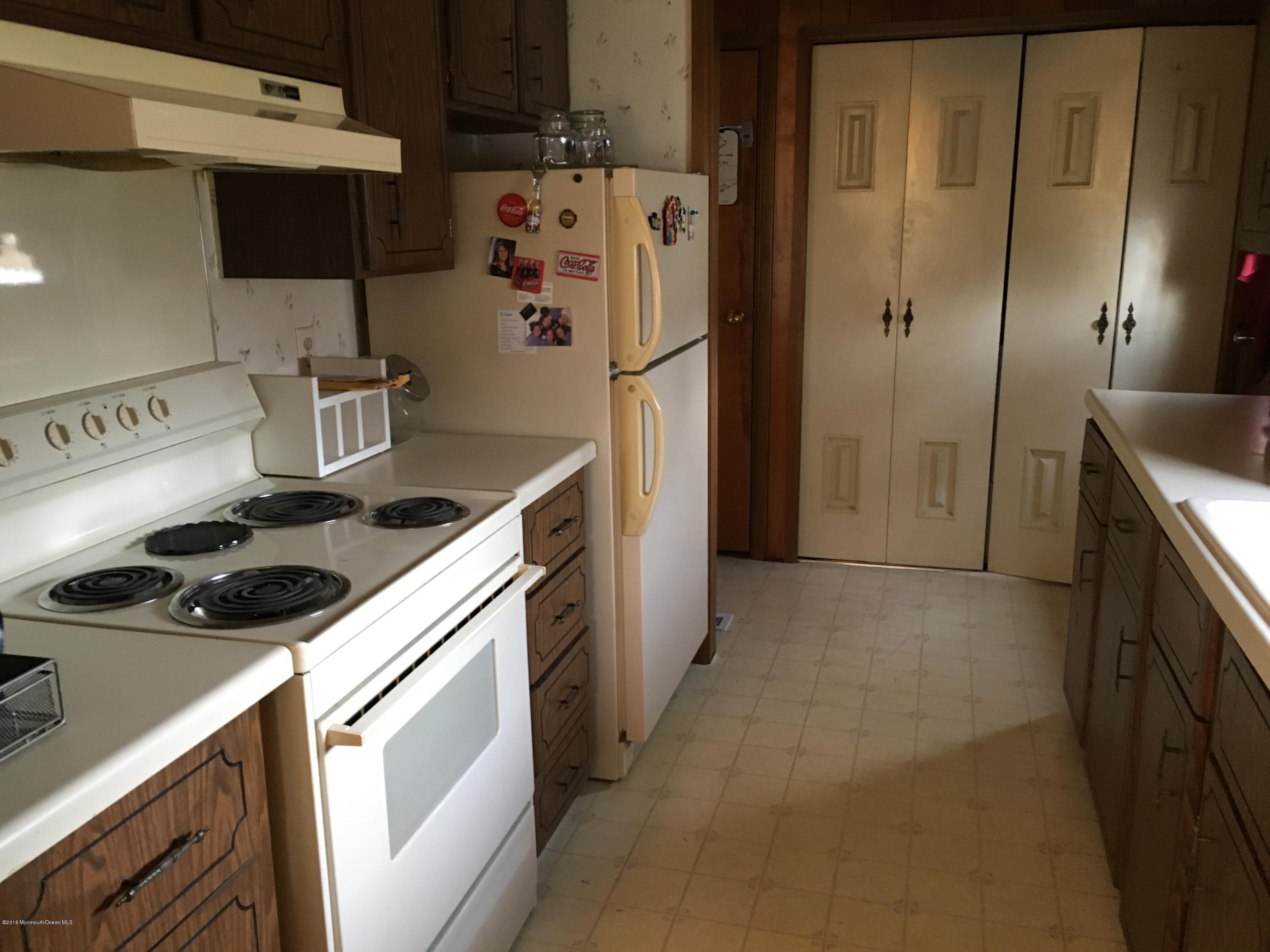 571 Cherin Road Freehold, NJ 07728 - Photo 8 of 17 a kitchen with a refrigerator sink and stove