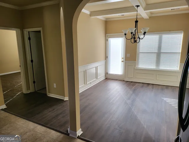 a view of a room with wooden floor and windows