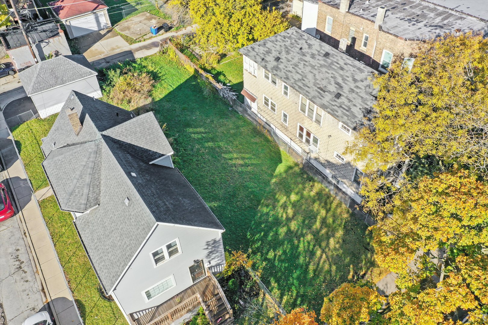 11442 South Prairie Avenue Chicago, IL 60628 - Photo 4 of 6 an aerial view of a house with swimming pool and large trees