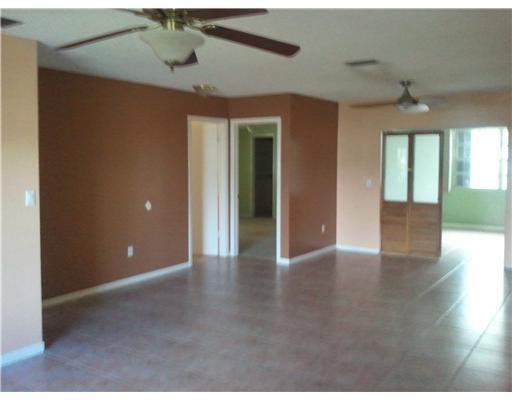 10914 Gable Street Boca Raton, FL 33428 - Photo 3 of 6 a view of an empty room with window and wooden floor