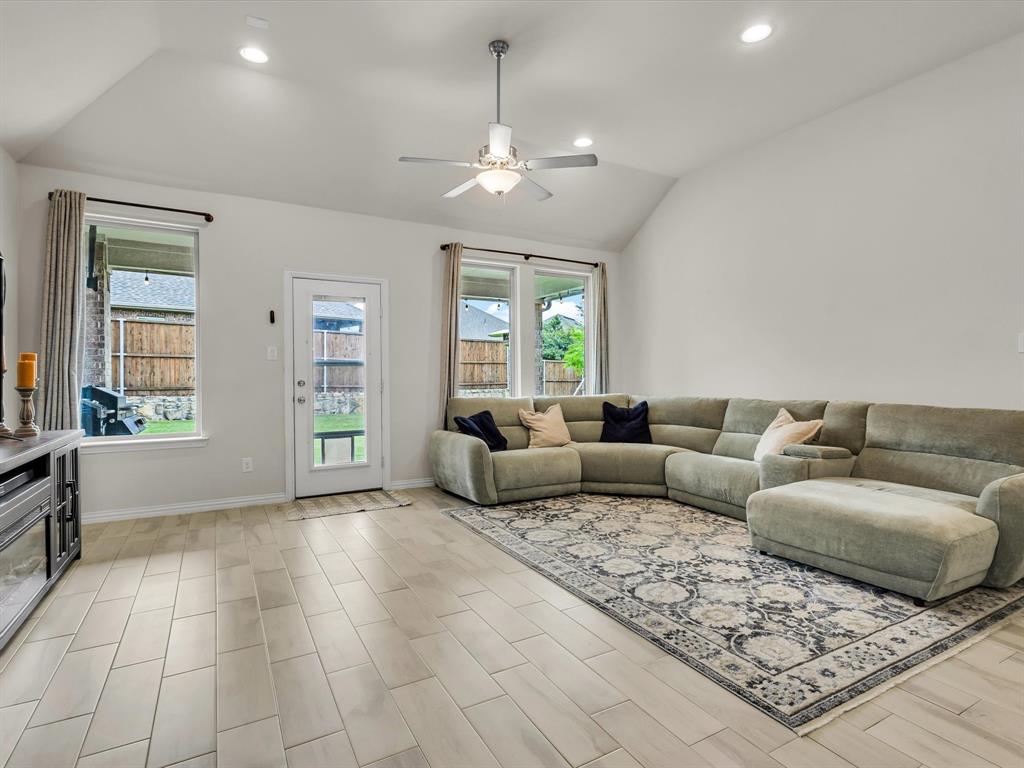 916 Monarch Lane Celina, TX 75009 - Photo 11 of 26 a living room with furniture and a chandelier