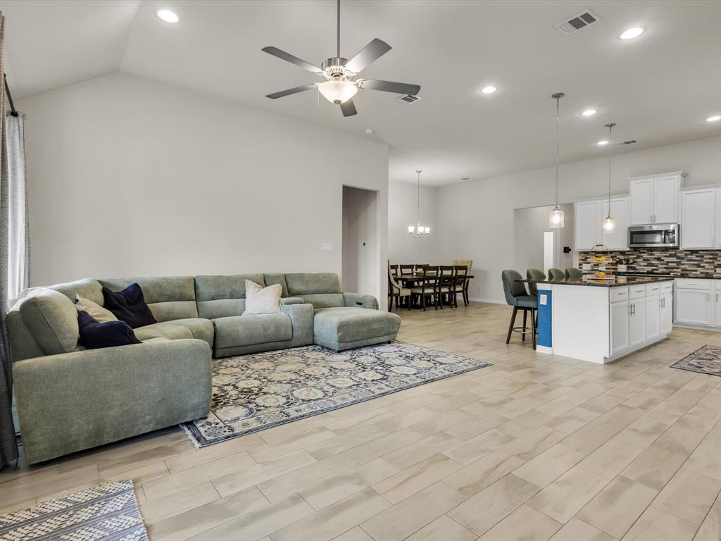 916 Monarch Lane Celina, TX 75009 - Photo 12 of 26 a living room with furniture and kitchen view