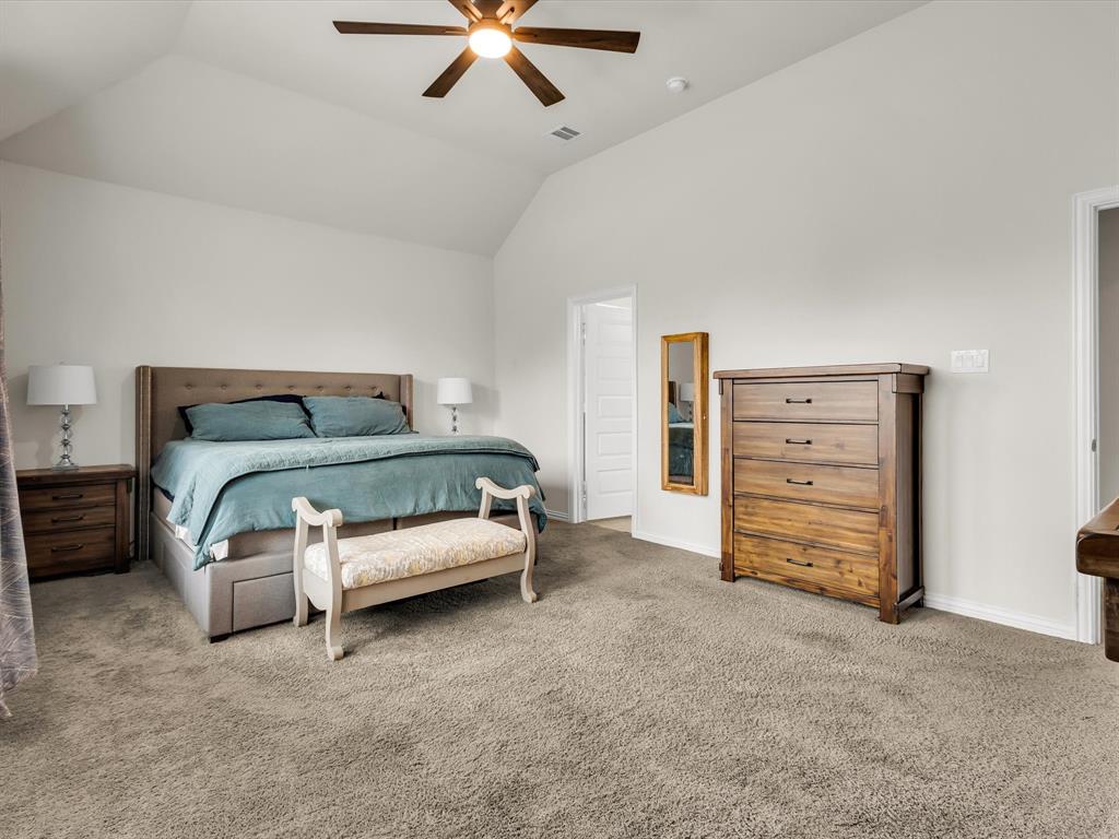 916 Monarch Lane Celina, TX 75009 - Photo 13 of 26 a bedroom with a bed and a couch