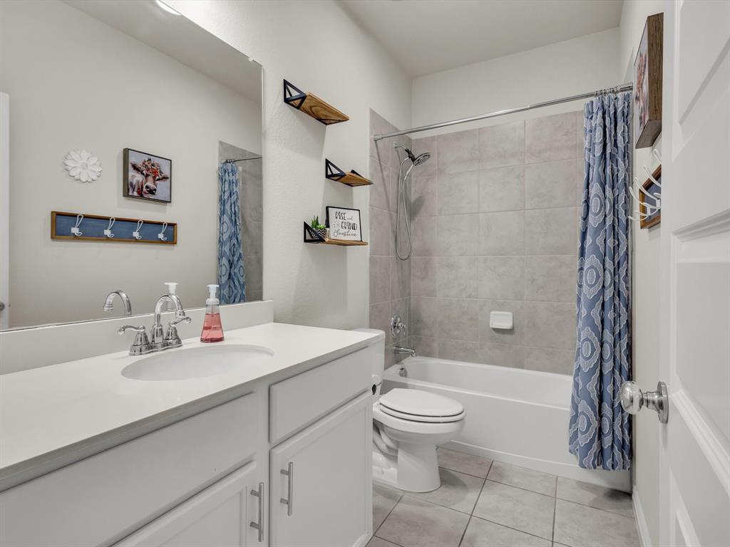 916 Monarch Lane Celina, TX 75009 - Photo 18 of 26 a bathroom with a sink toilet and shower