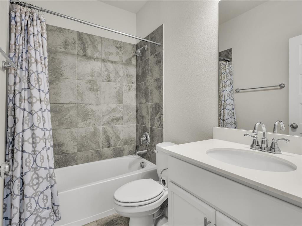 916 Monarch Lane Celina, TX 75009 - Photo 22 of 26 a bathroom with a sink toilet and shower