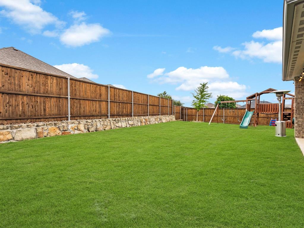 916 Monarch Lane Celina, TX 75009 - Photo 23 of 26 a view of a backyard with a garden