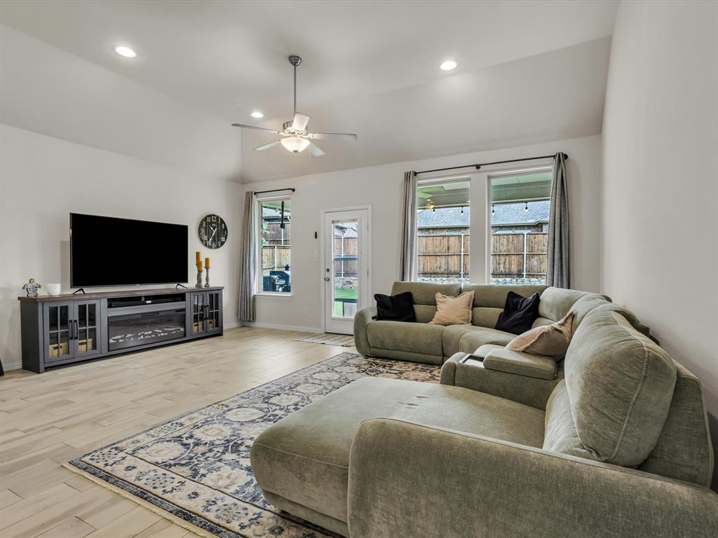 916 Monarch Lane Celina, TX 75009 - Photo 10 of 26 a living room with furniture and a flat screen tv