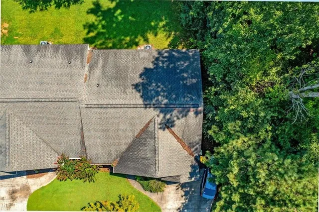 an aerial view of a house with a yard