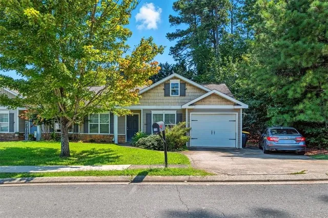 a front view of house with yard and green space