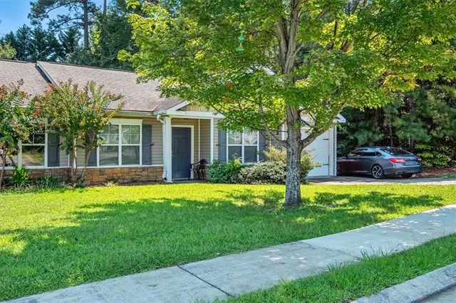 a front view of house with yard and green space