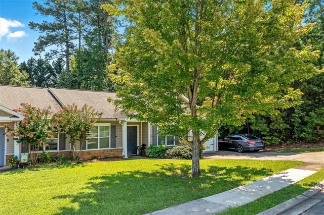 a swimming pool with outdoor seating and yard