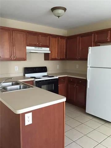 a kitchen with stainless steel appliances a refrigerator sink and cabinets