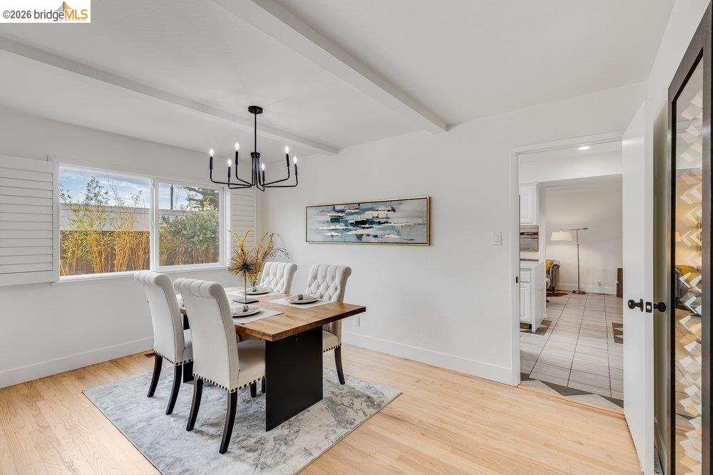 1298 Ribbon Street Foster City, CA 94404 - Photo 26 of 86 Open-concept dining area featuring light wood-finish flooring, white walls, and exposed ceiling beams