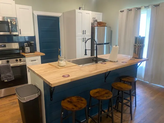 a kitchen with a table chairs and refrigerator