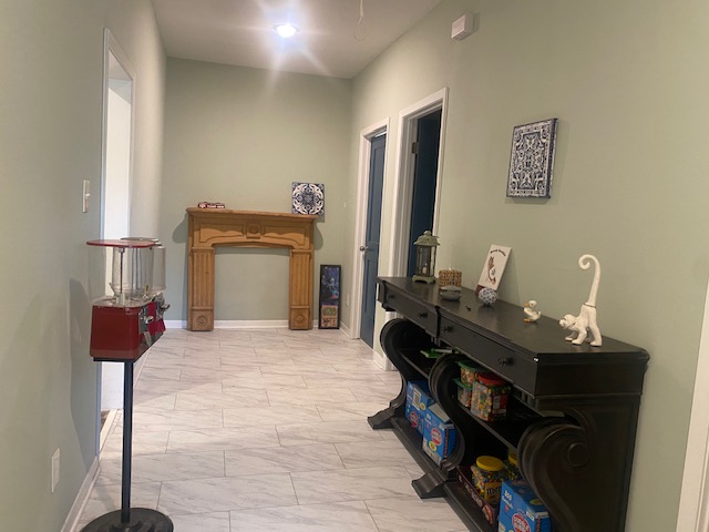 701 West 28th Street Bryan, TX 77803 - Photo 8 of 17 Hall with light marble finish floors and baseboards