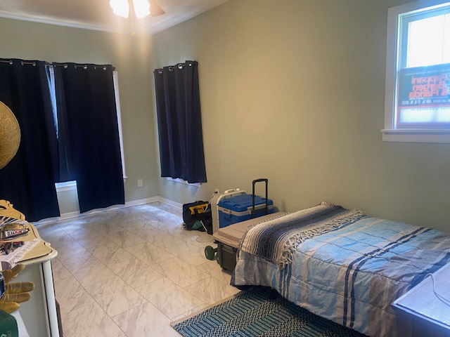 701 West 28th Street Bryan, TX 77803 - Photo 9 of 17 Bedroom with light marble finish floors and ornamental molding