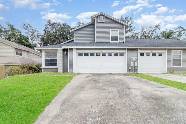 a view of a house with a yard and garage