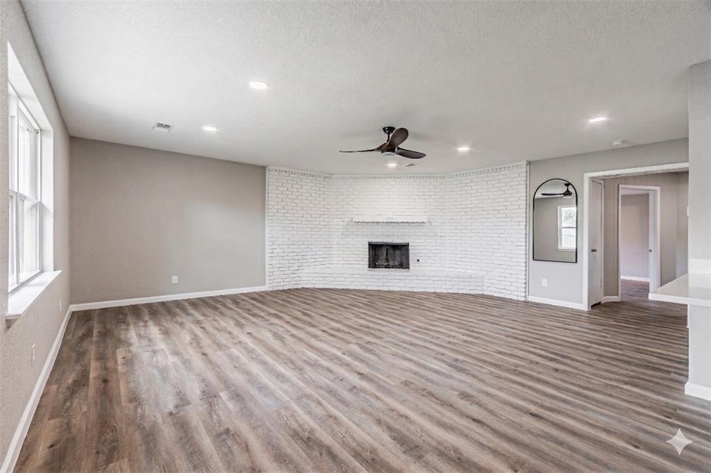 1160 Harrison Lane Hurst, TX 76053 - Photo 12 of 34 a view of empty room with wooden floor and fan