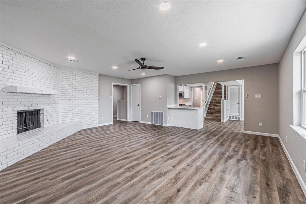 1160 Harrison Lane Hurst, TX 76053 - Photo 13 of 34 a view of empty room with wooden floor and fireplace
