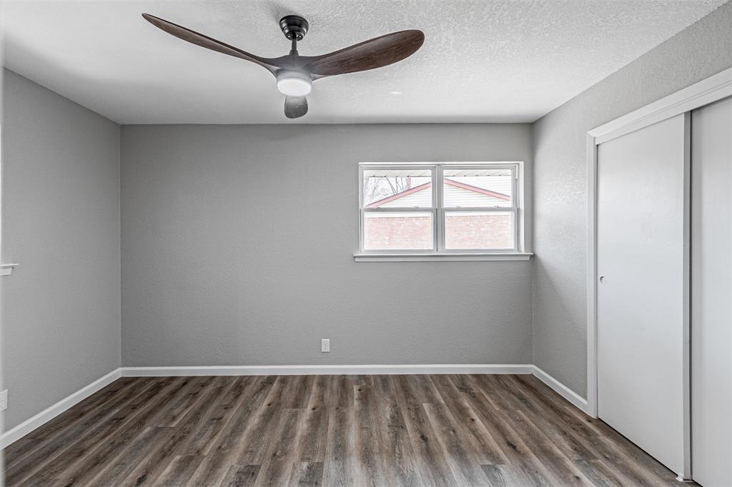 1160 Harrison Lane Hurst, TX 76053 - Photo 18 of 34 wooden floor in an empty room with a window