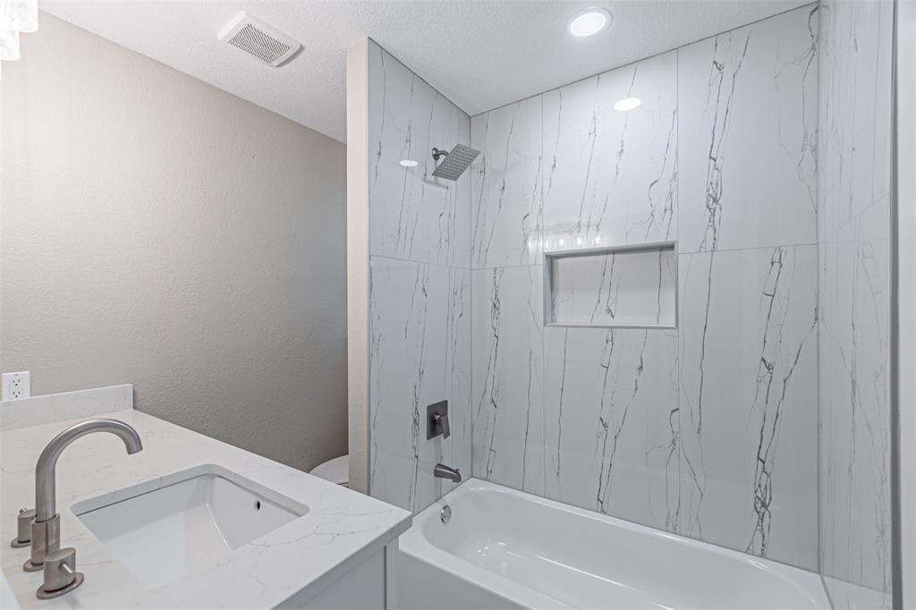 1160 Harrison Lane Hurst, TX 76053 - Photo 20 of 34 a bathroom with a sink and a bathtub