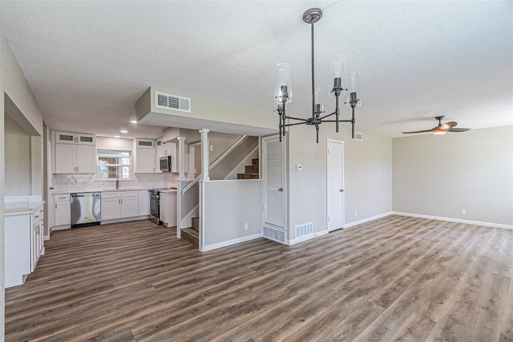 1160 Harrison Lane Hurst, TX 76053 - Photo 6 of 34 a view of a kitchen with wooden floor and electronic appliances