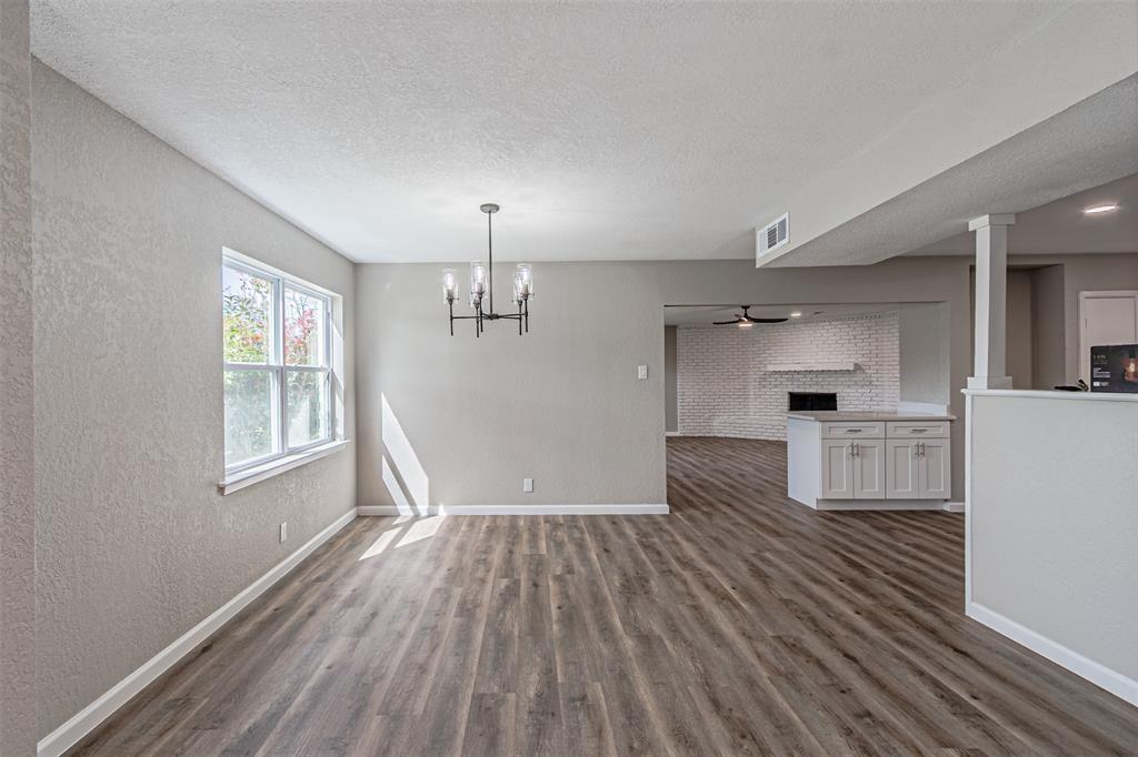 1160 Harrison Lane Hurst, TX 76053 - Photo 8 of 34 a view of empty room with wooden floor and window