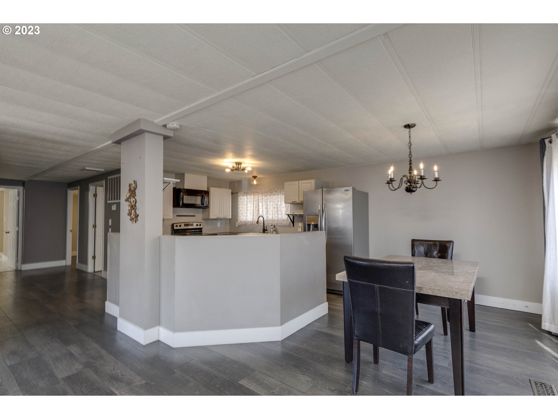 9700 Southwest Tualatin Road, Unit 32 Tualatin, OR 97062 - Photo 9 of 23 a view of a dining room with furniture and wooden floor