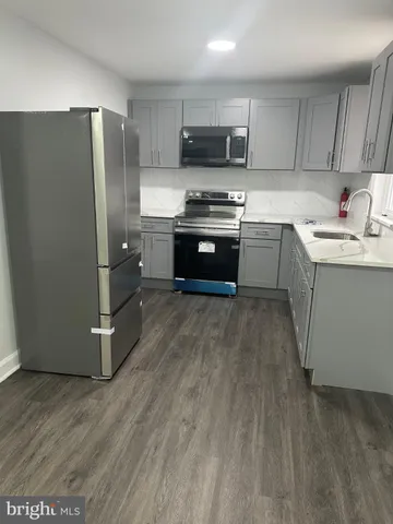 a kitchen with stainless steel appliances a refrigerator stove and sink