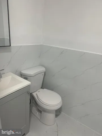 a white toilet sitting next to a white sink