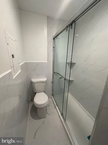 a bathroom with a toilet and a shower
