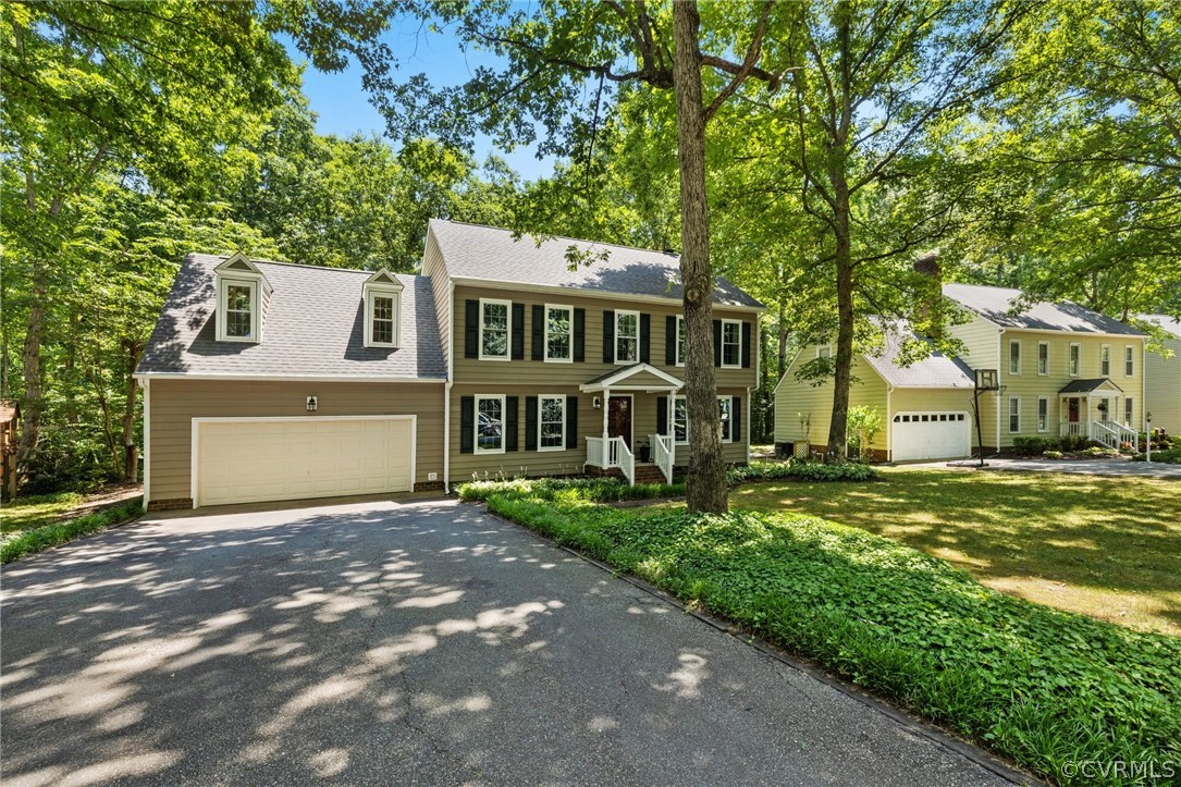 13817 Shadow Ridge Road Midlothian, VA 23112 - Photo 2 of 34 a front view of a house with a yard and garage