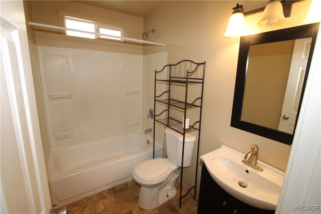 42695 Moonridge Road, Unit A Big Bear Lake, CA 92315 - Photo 10 of 12 a bathroom with a sink toilet and shower