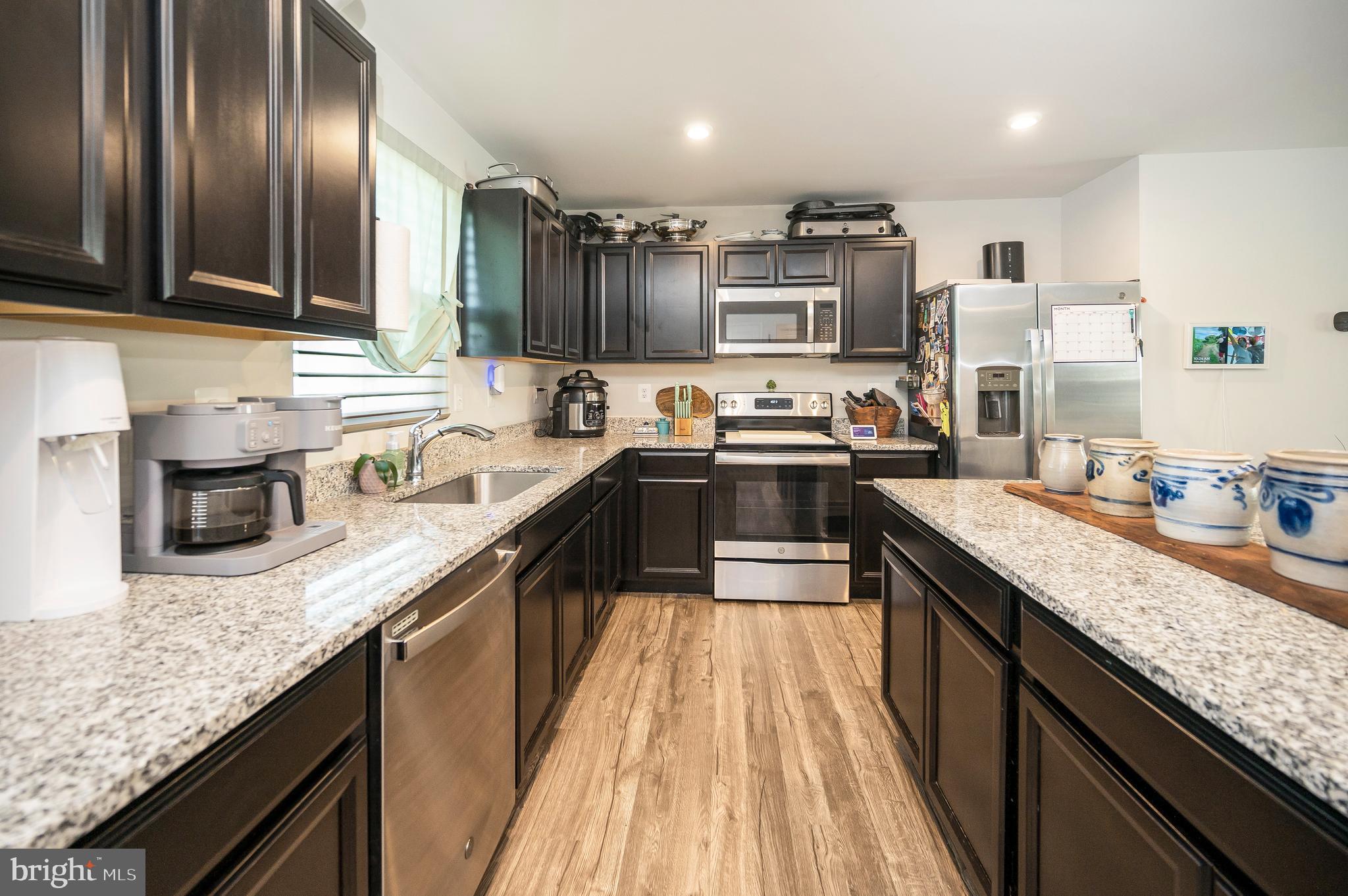 12062 Rundle Crossing King George, VA 22485 - Photo 11 of 67 a kitchen with stainless steel appliances granite countertop sink stove microwave and cabinets
