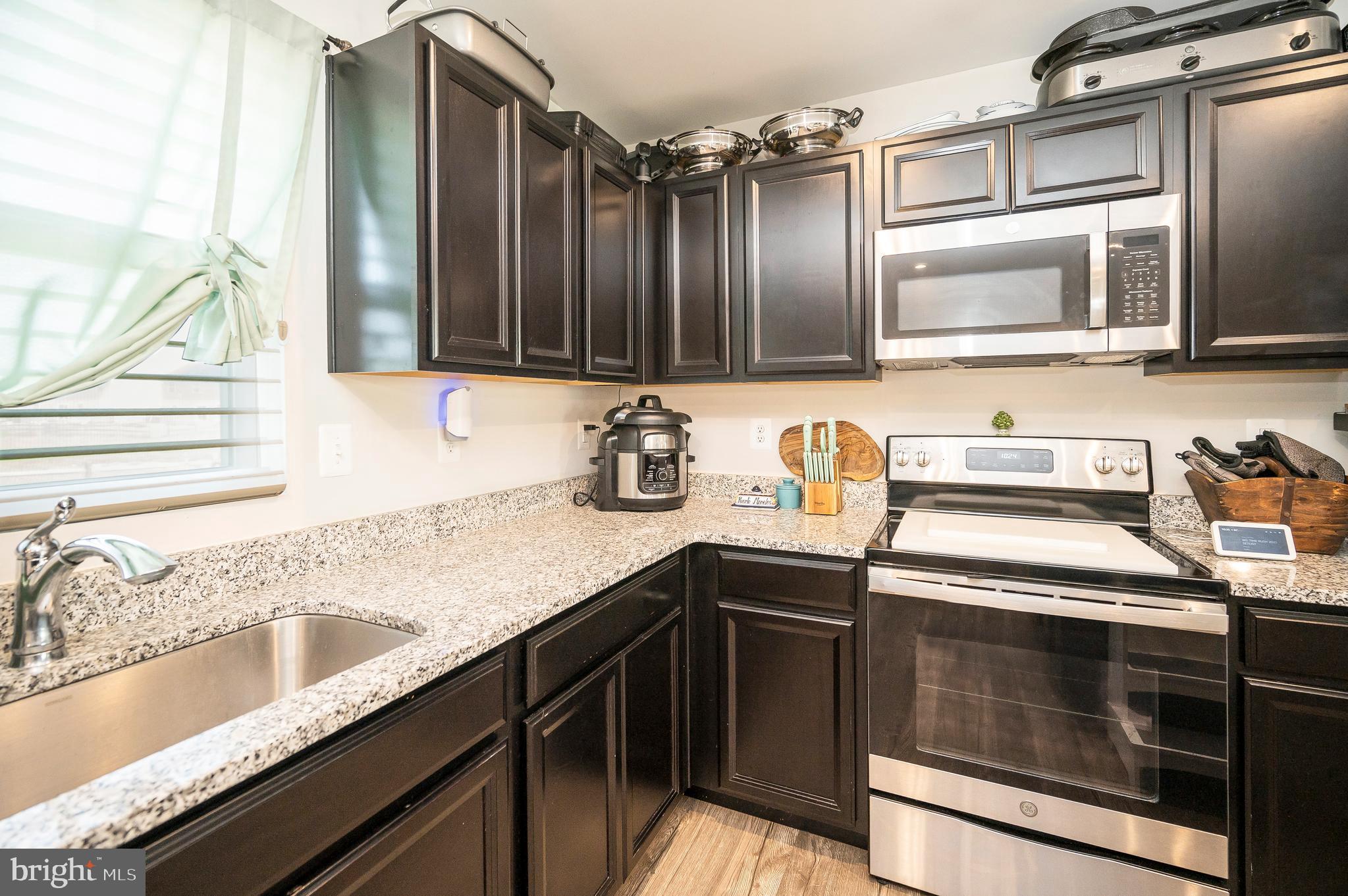 12062 Rundle Crossing King George, VA 22485 - Photo 14 of 67 a kitchen with granite countertop a sink stainless steel appliances and cabinets
