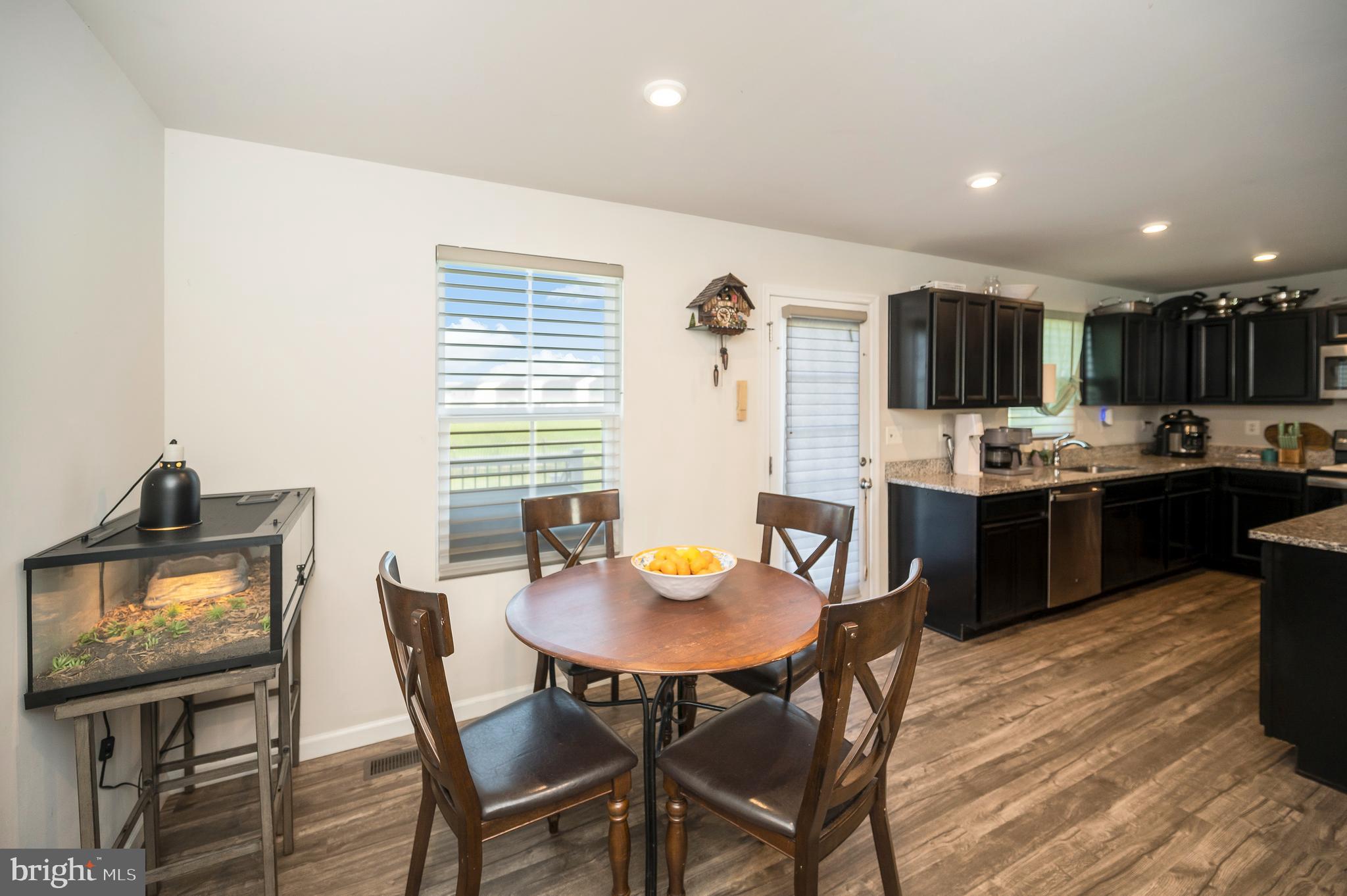12062 Rundle Crossing King George, VA 22485 - Photo 17 of 67 a open kitchen with a dining table and chairs