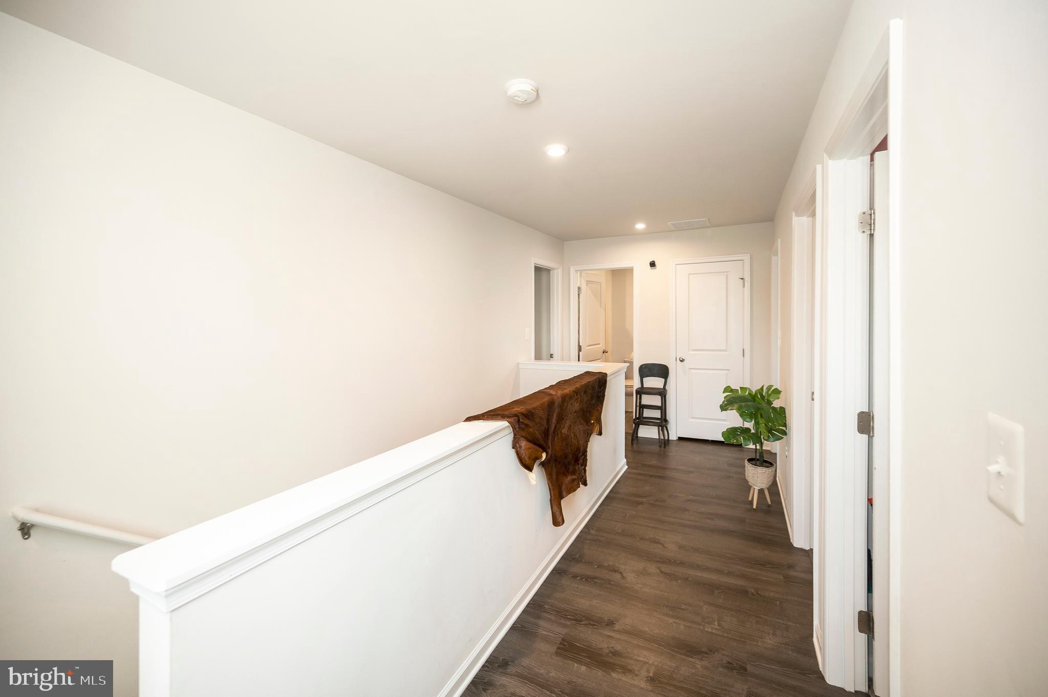 12062 Rundle Crossing King George, VA 22485 - Photo 24 of 67 a hallway with wooden floor and staircase