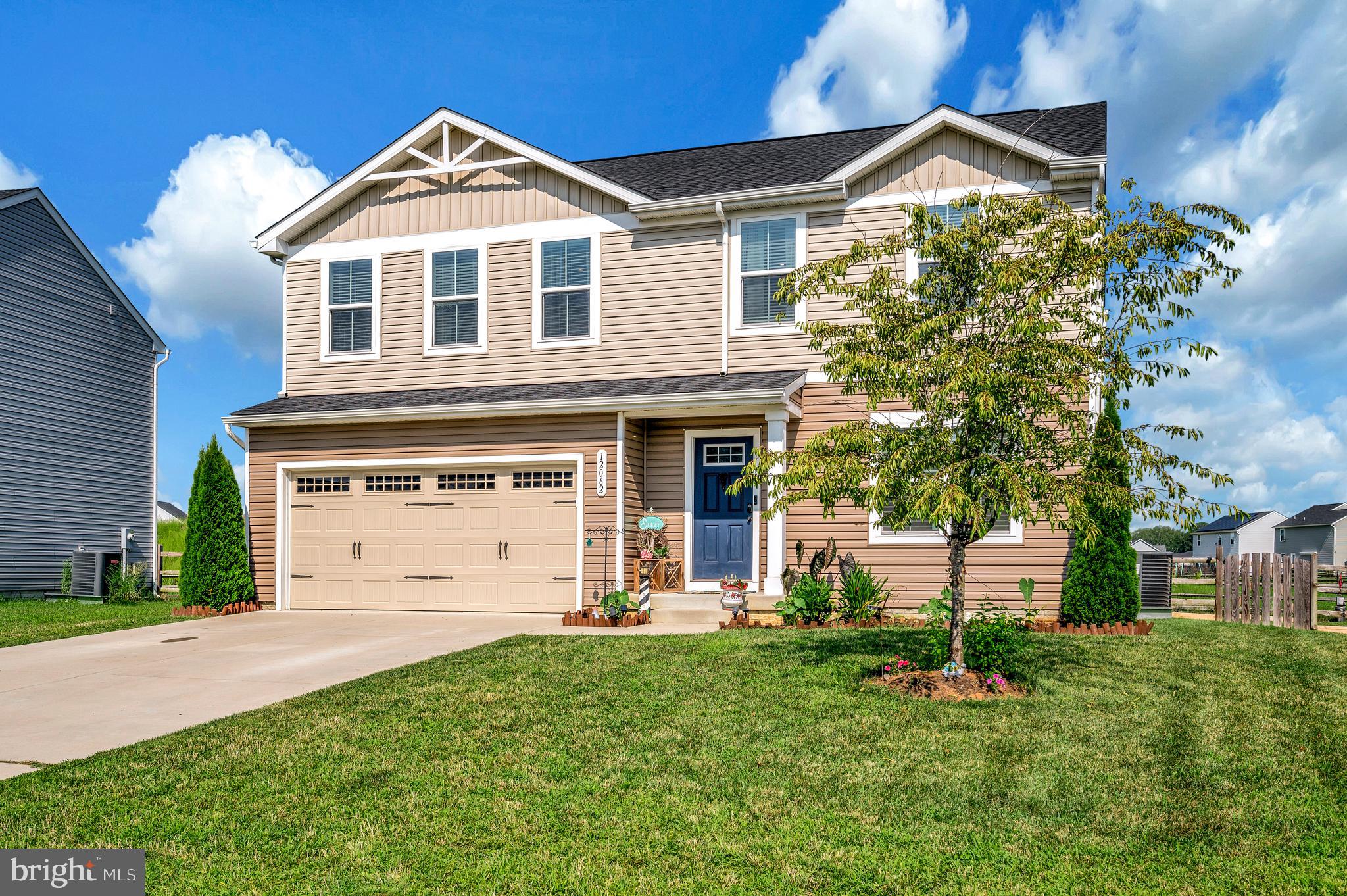 12062 Rundle Crossing King George, VA 22485 - Photo 4 of 67 a front view of a house with a yard and garage