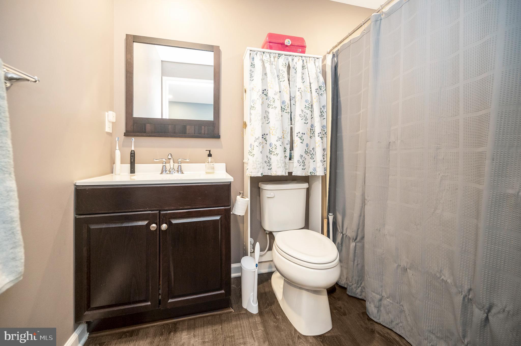 12062 Rundle Crossing King George, VA 22485 - Photo 41 of 67 a bathroom with a toilet sink vanity and mirror