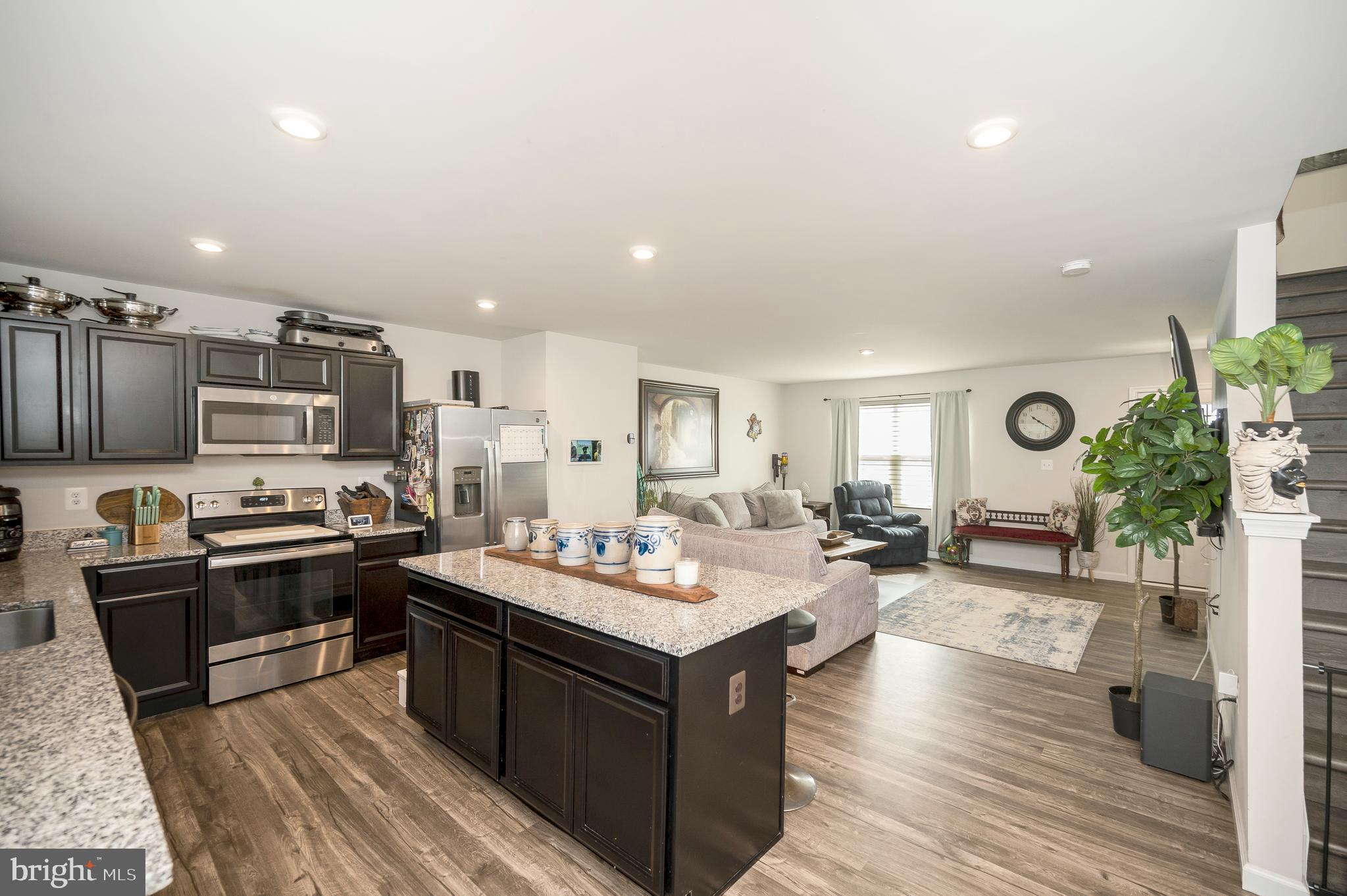 12062 Rundle Crossing King George, VA 22485 - Photo 10 of 67 a large kitchen with stainless steel appliances granite countertop a lot of counter space and wooden floor