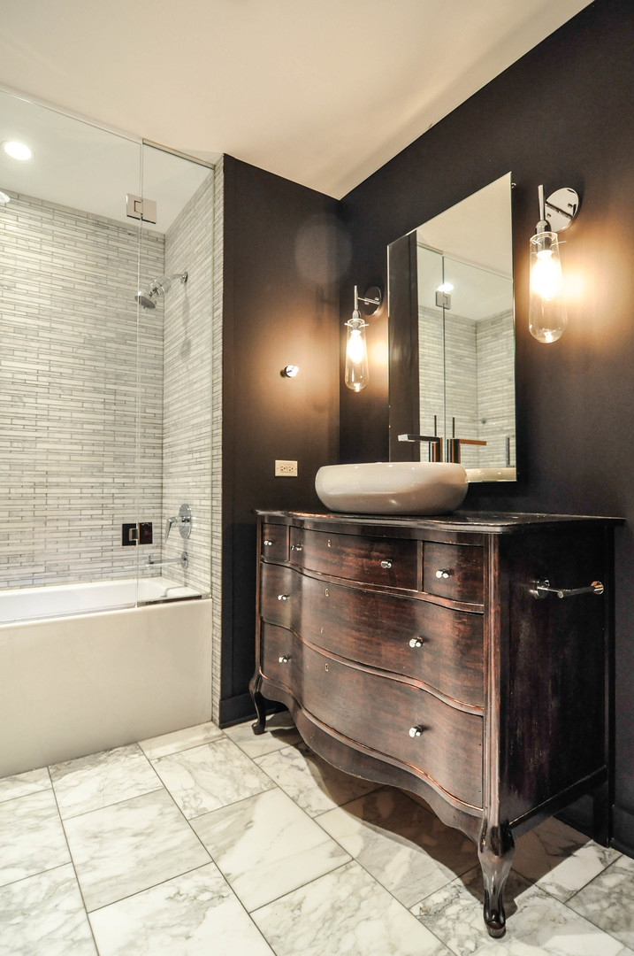 8 East Randolph Street, Unit 2807 Chicago, IL 60601 - Photo 15 of 37 a bathroom with a bathtub a shower a sink and a mirror